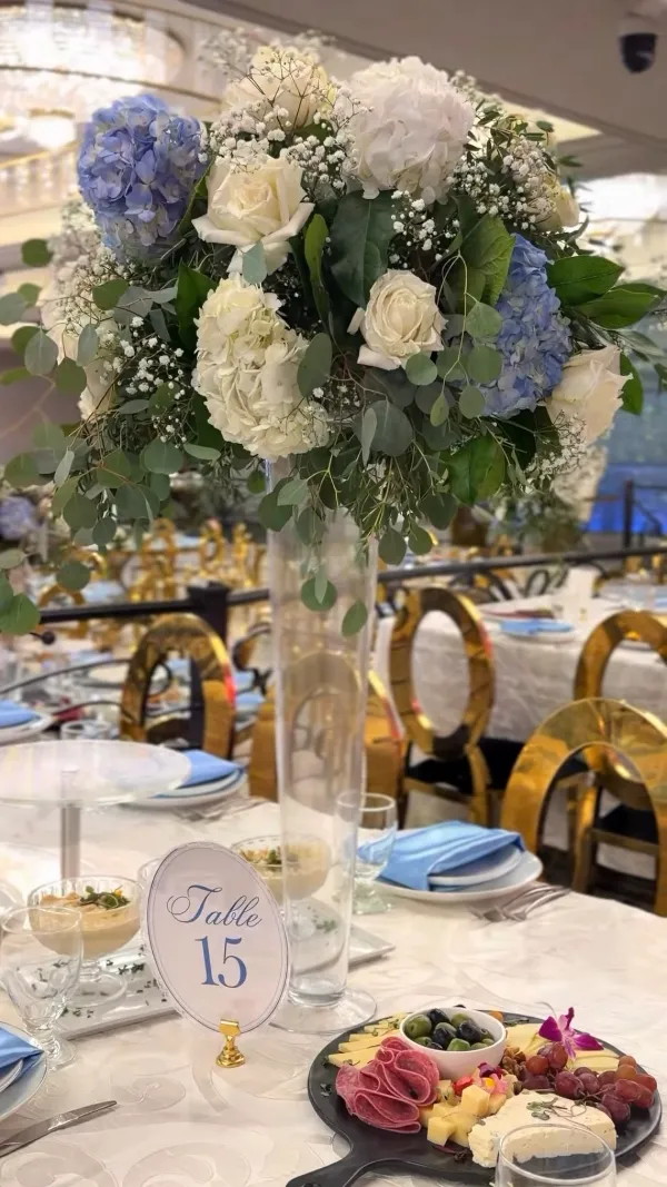 Elegant grazing table with fruit, cheeses and blue hydrangeas