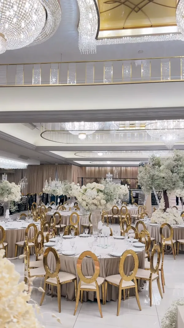 Ballroom set for a celebration with white florals